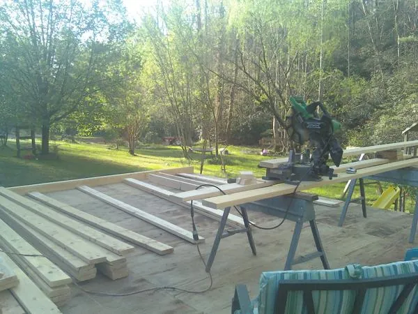 Miter saw and framing lumber on a deck under construction in Doniphan